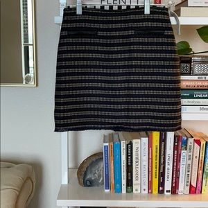 Tweed mini skirt with leather trim